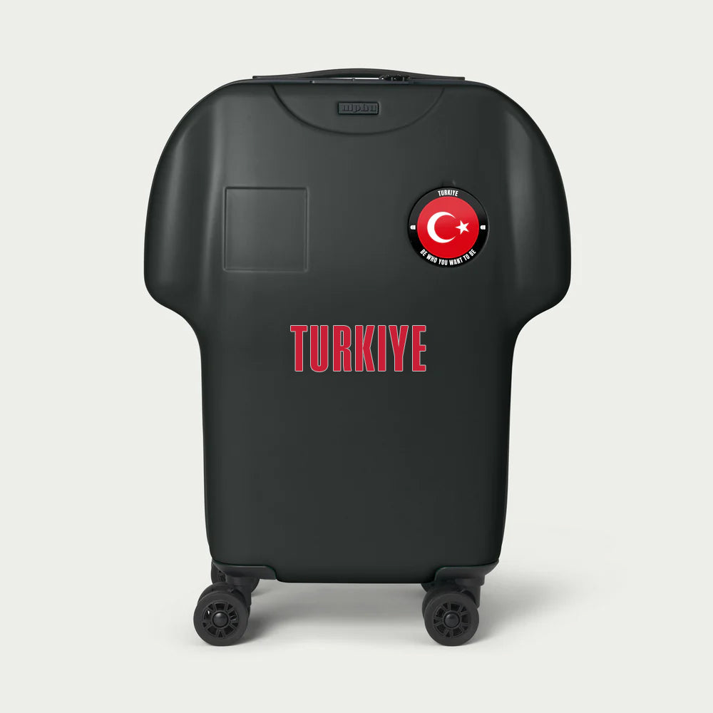 Black suitcase with Turkish flag and 'TURKIYE' text on a light gray background