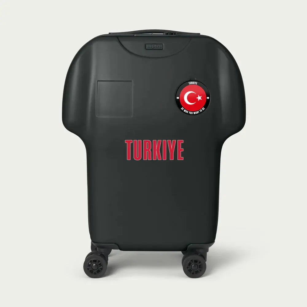 Black suitcase with Turkish flag and 'TURKIYE' text on a light gray background