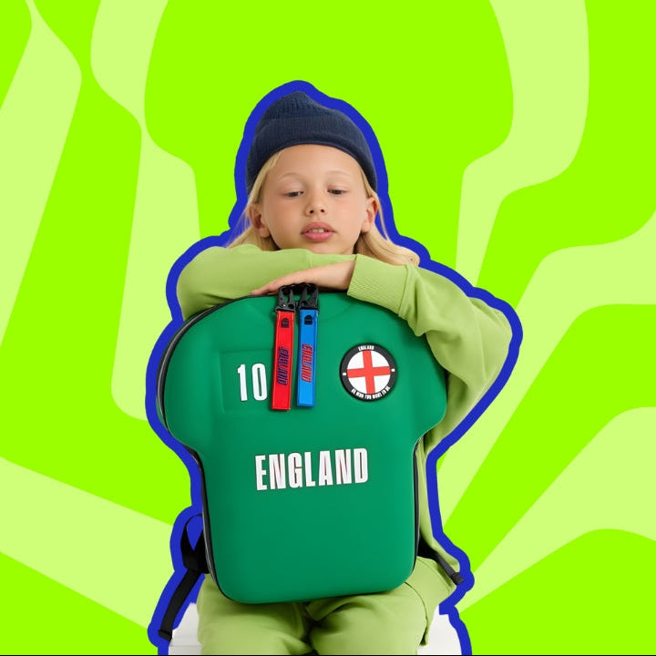 Child wearing a green England jersey with a blue outline against a green wavy background