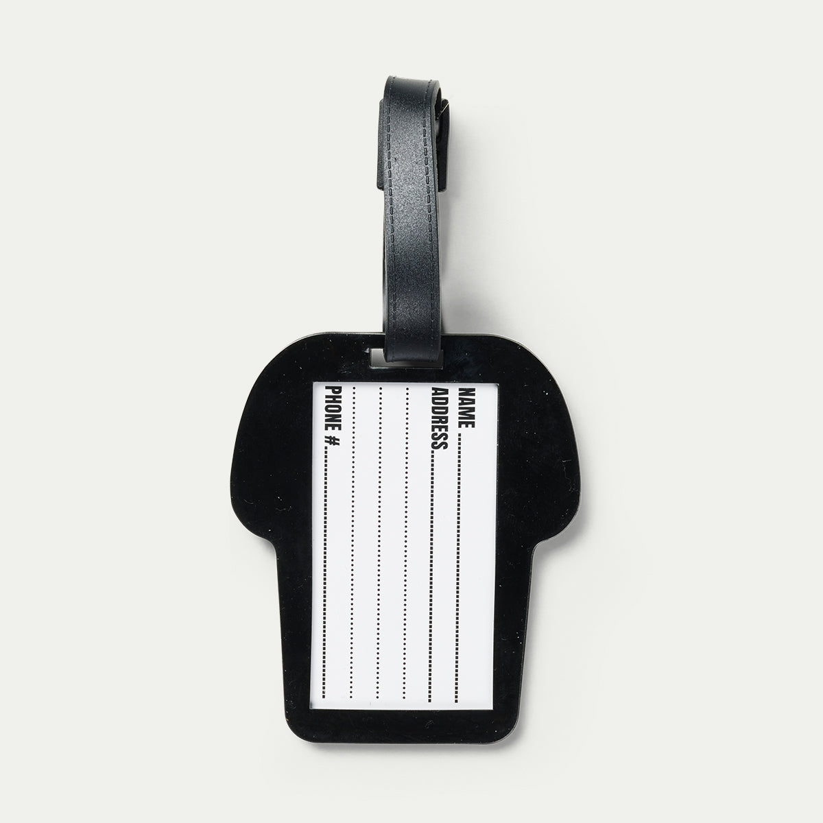 Black luggage tag with a white label on a light gray background