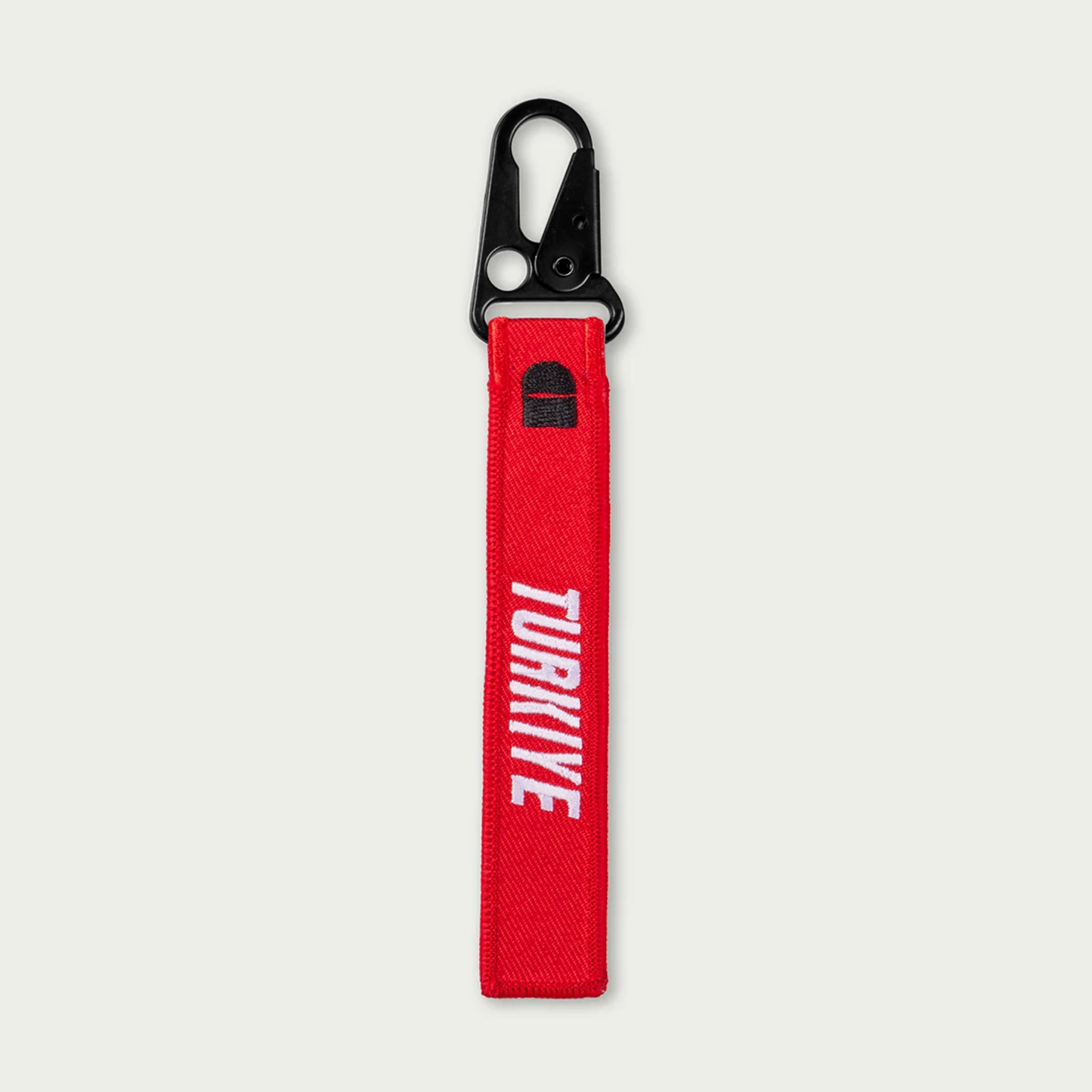Red keychain with 'TURKIYE' text and black carabiner on a white background