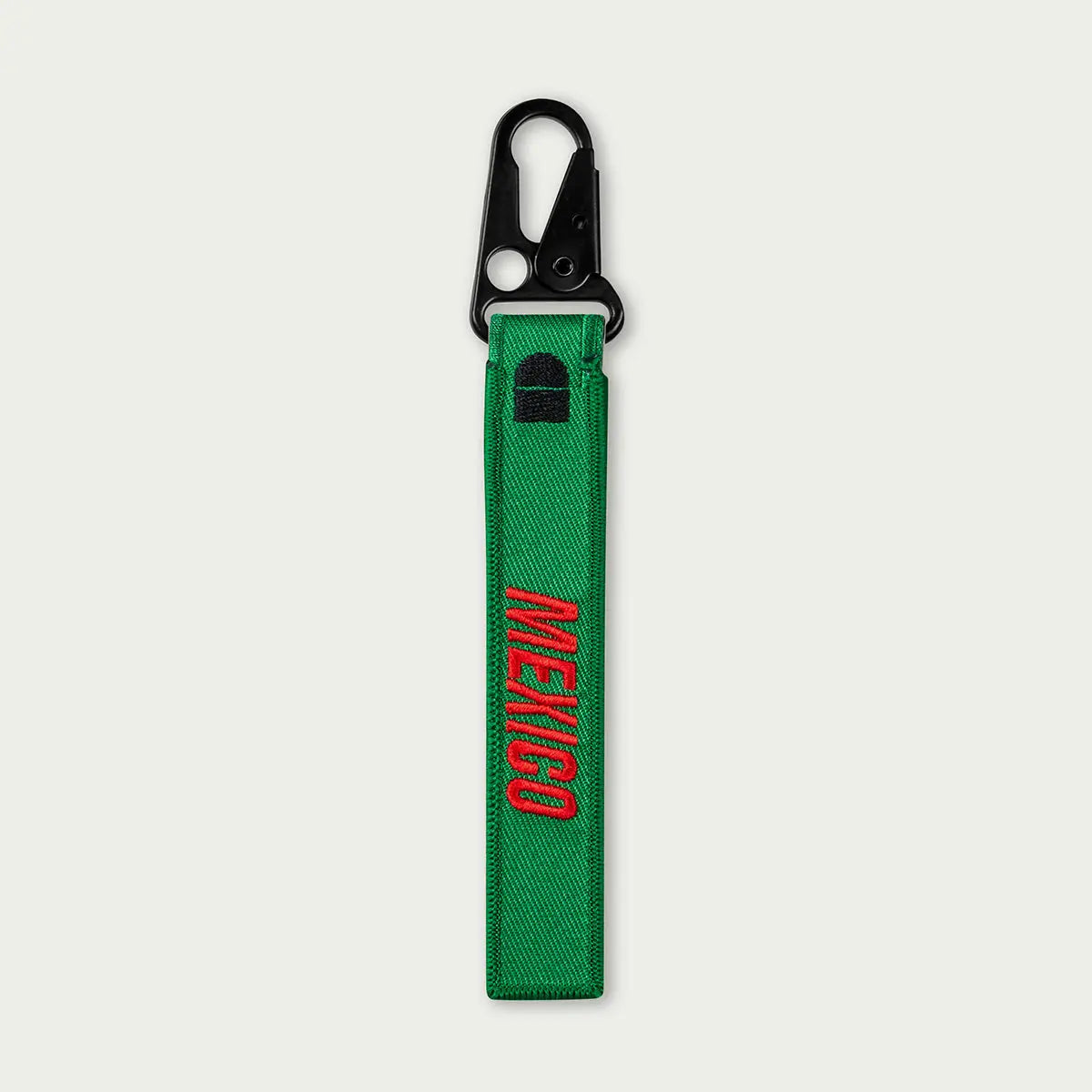 Green keychain with 'MEXICO' embroidery on a white background