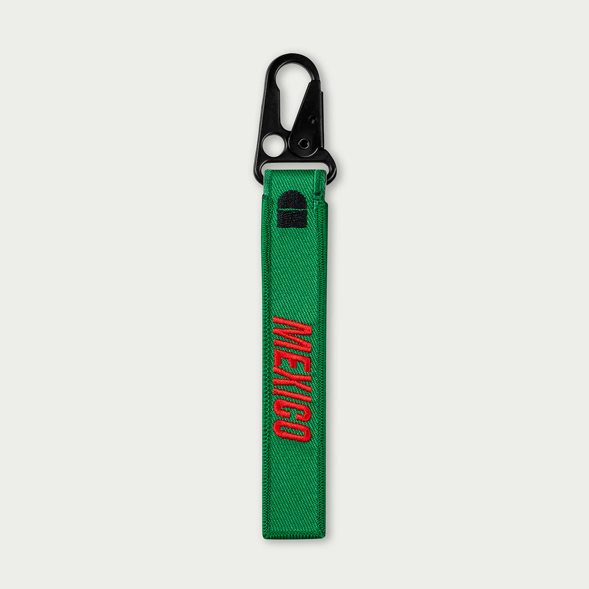 Green keychain with 'MEXICO' embroidery on a white background