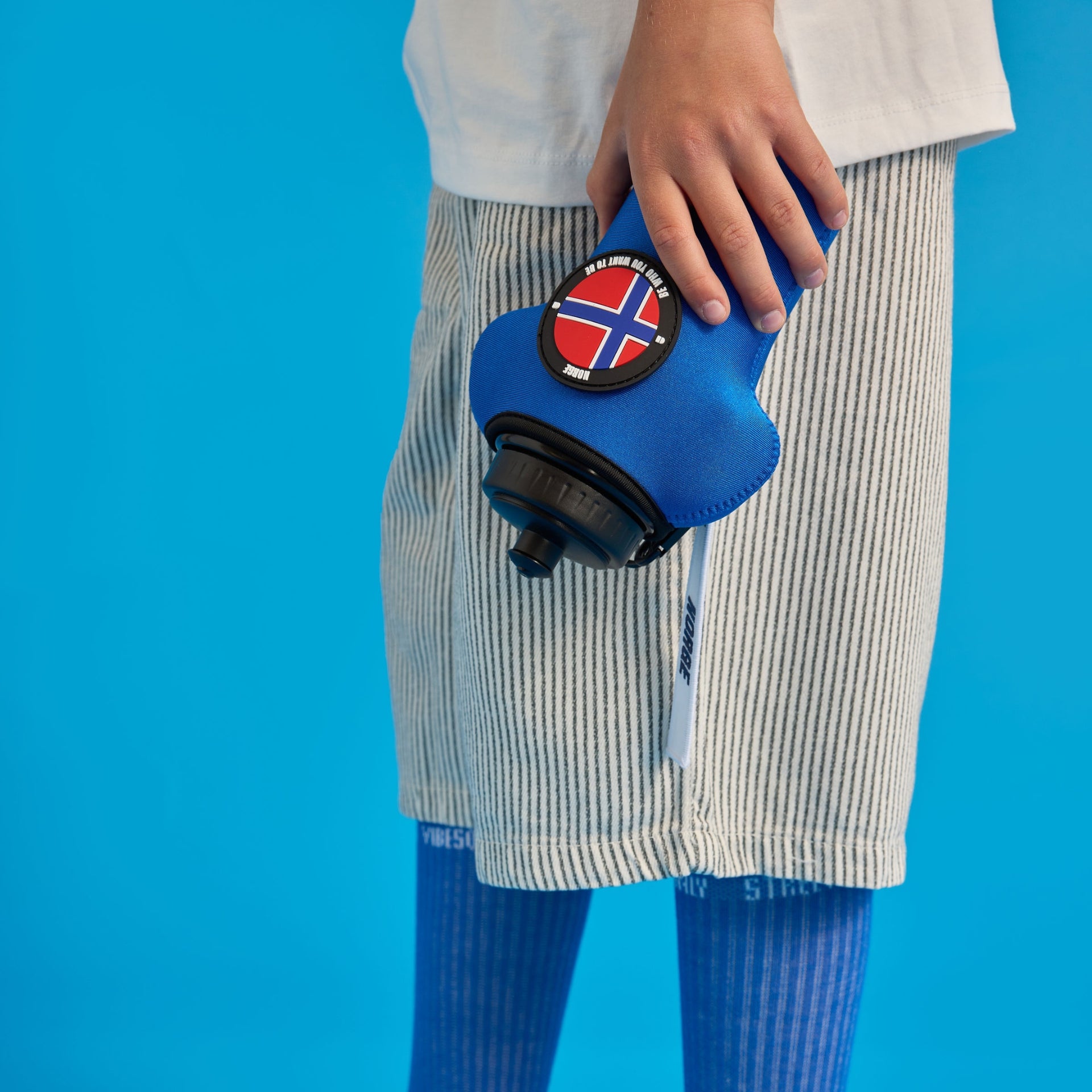 kid holding blue bottle with sleeve and velcro patch