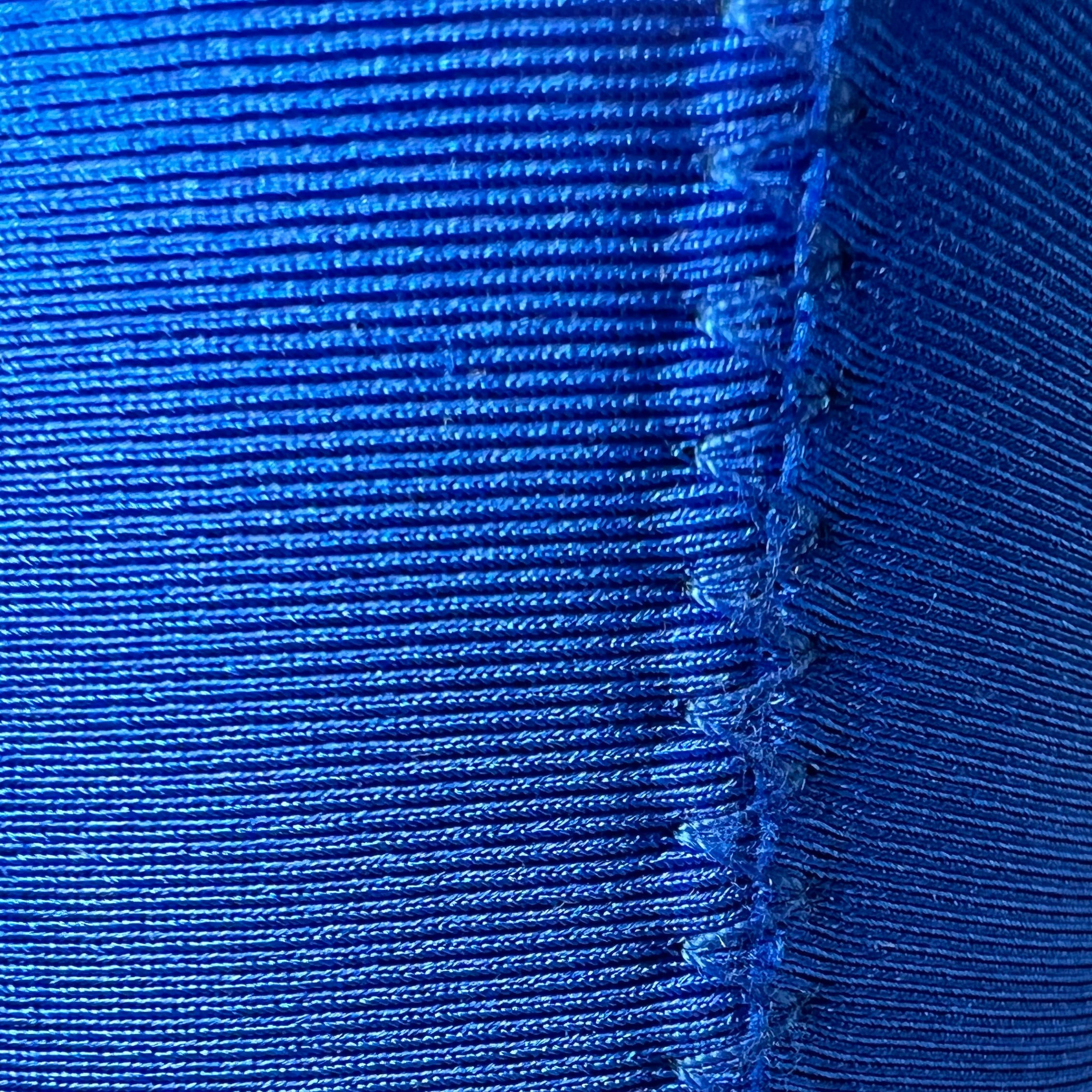 Close-up of blue fabric with a visible seam