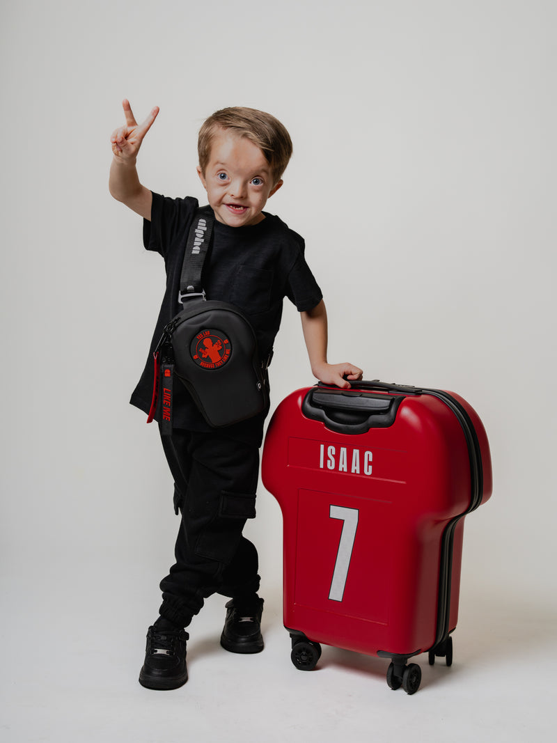 Child with a red suitcase and black backpack on a white background