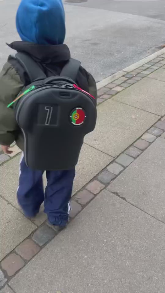 kid wearing customised black shirt-shaped medium backpack by alpha