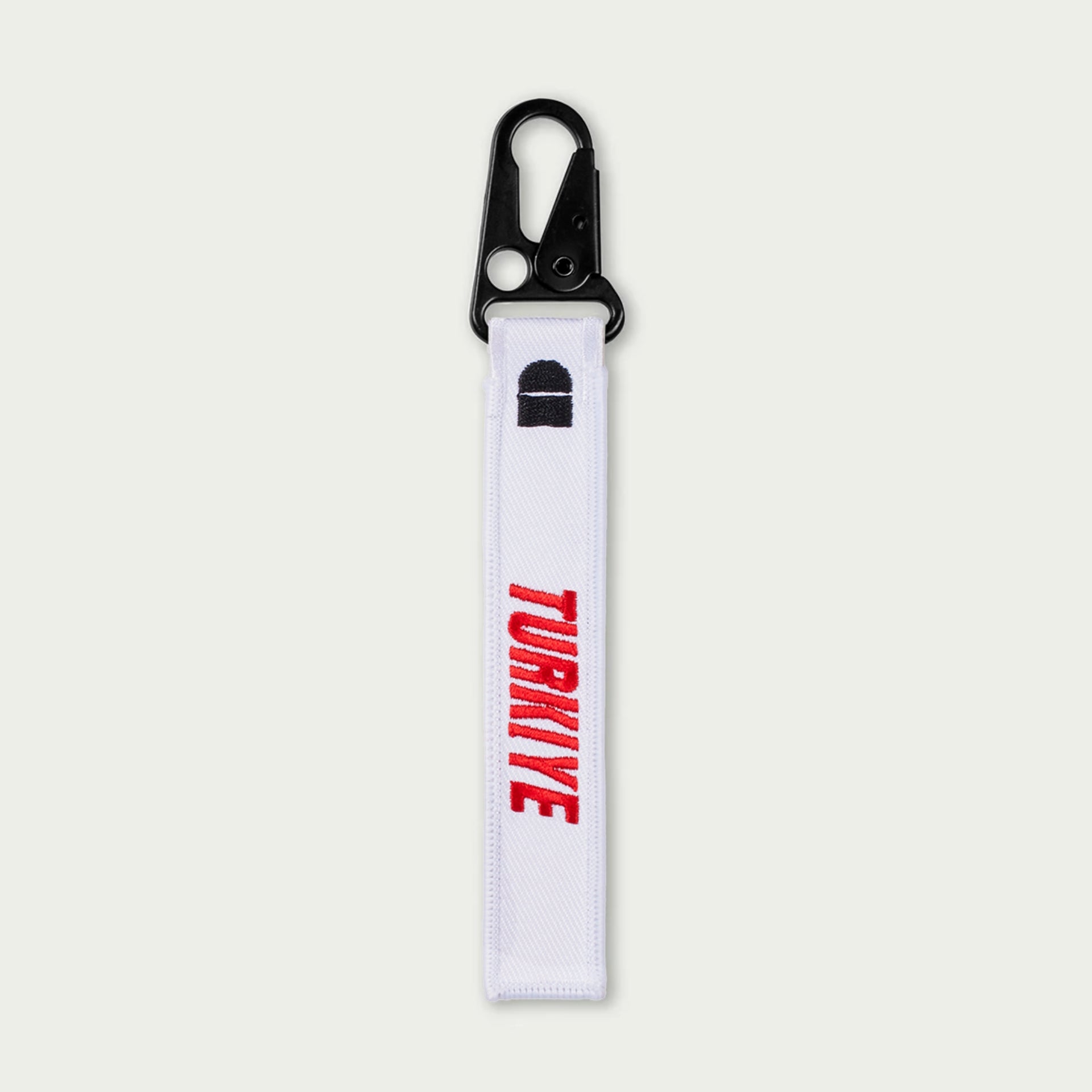 White keychain with 'TURKIYE' text on a light gray background